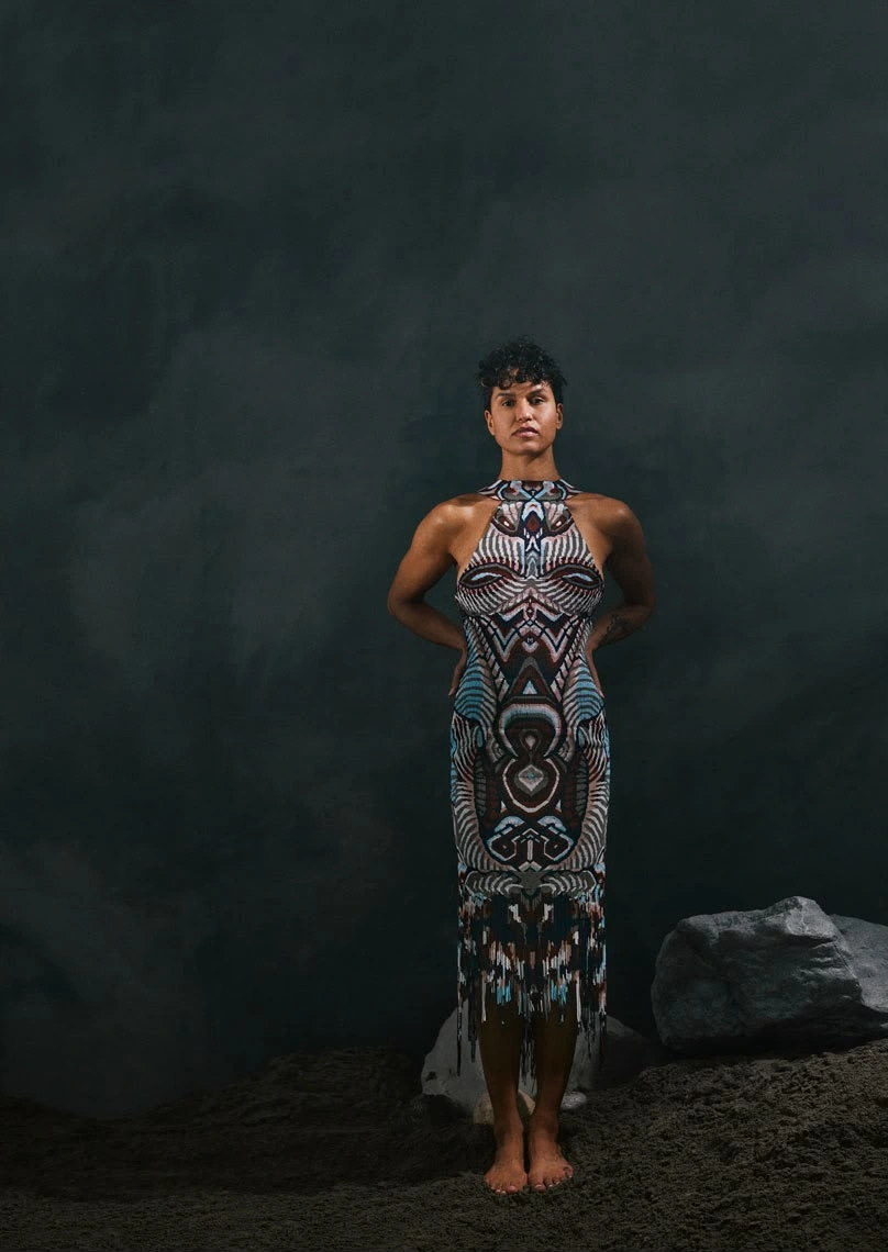 Maria Anouk standing and facing the camera in a patterned halter dress from Binhe. Design assistance and product design by Storm Nijhuis for Zyanya Keizer.