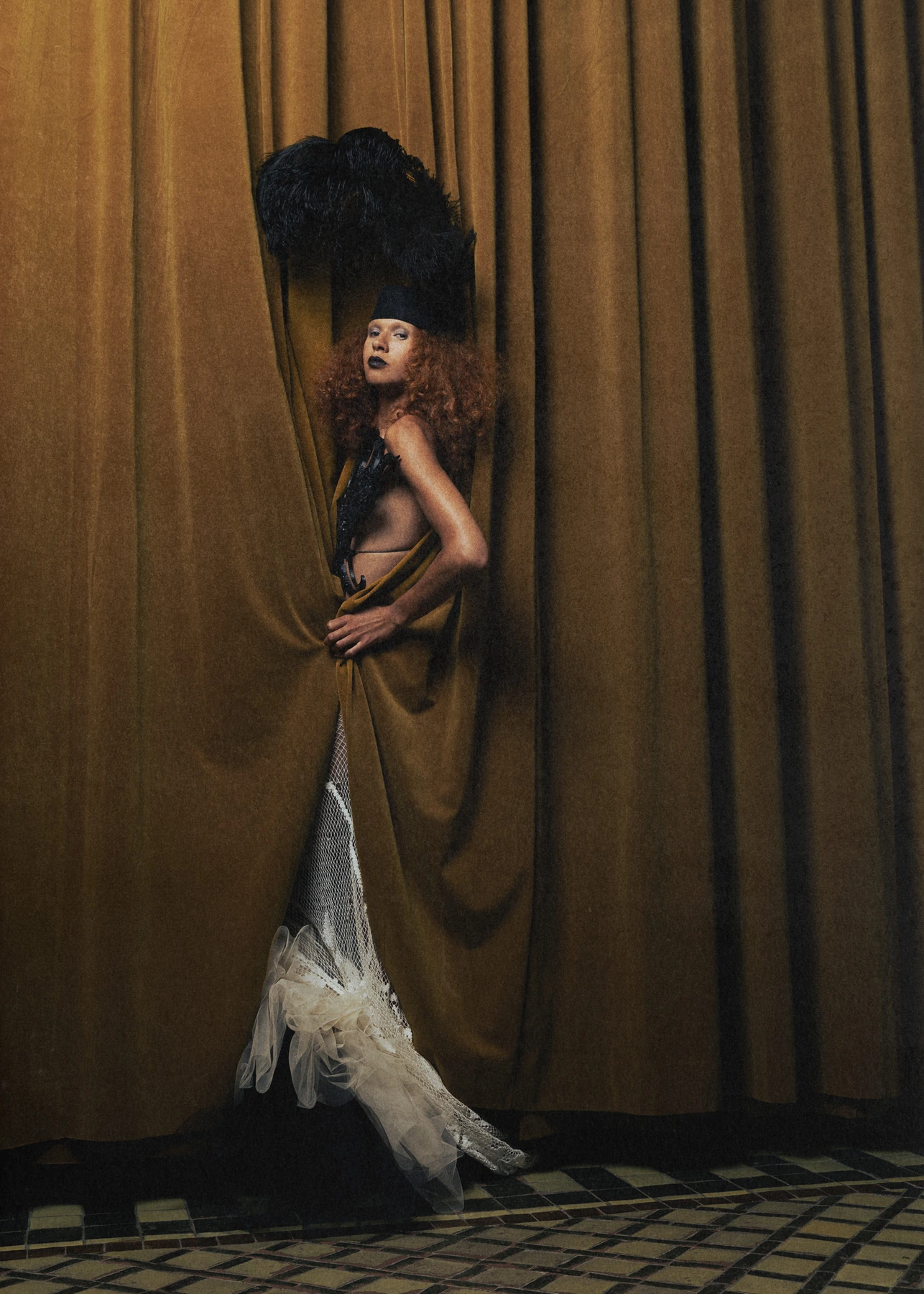 Full-length Hellion look with a feathered headpiece and a sheer skirt with a sweeping train.