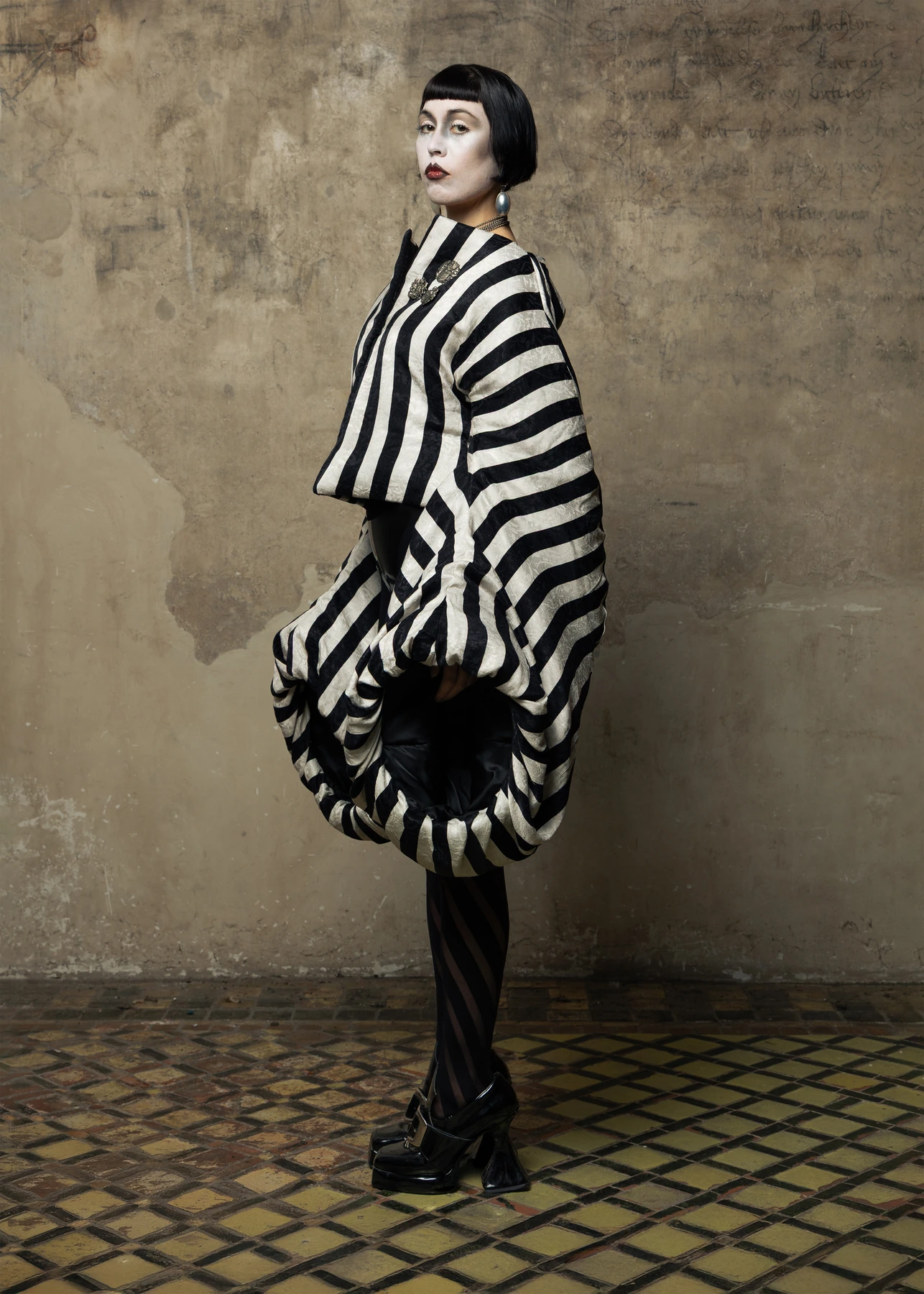 Hellion lookbook, look 01, alternate side view. Full garment silhouette.